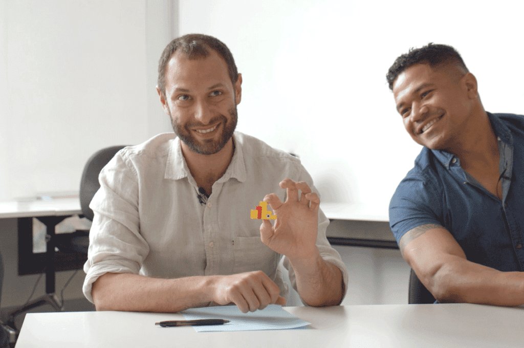 Facilitators exploring the LEGO® Serious Play® Method process potential through hands-on model building and collaborative team discussions.